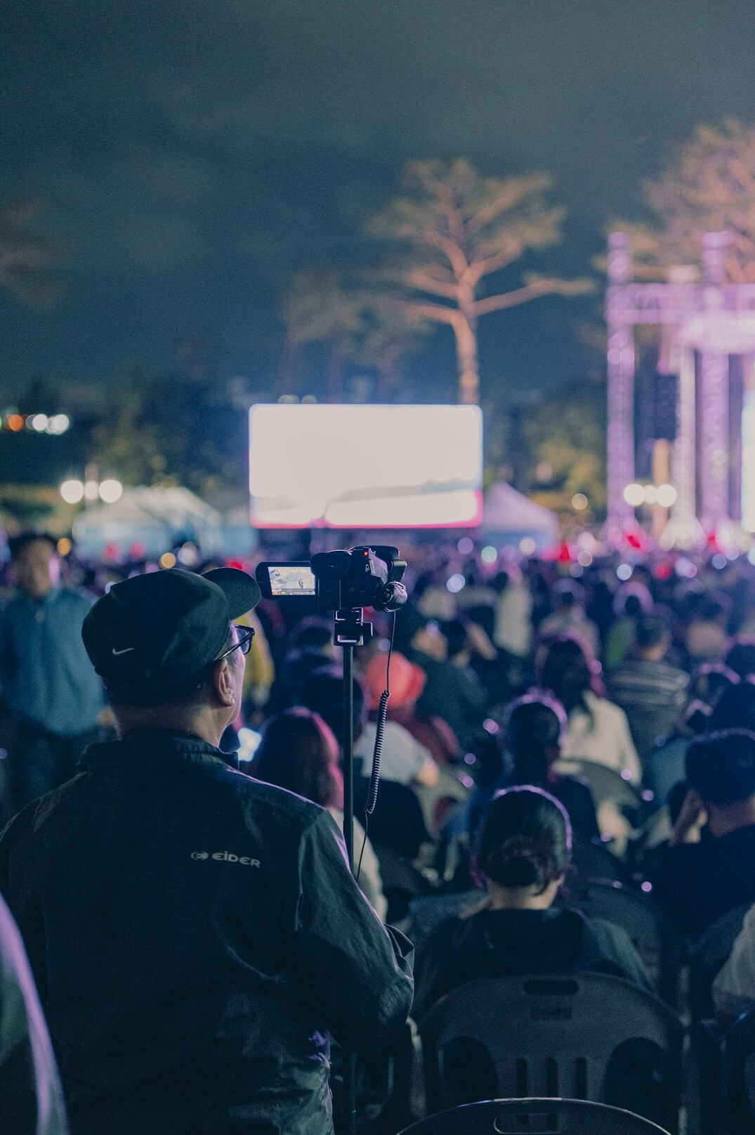 Media analyst reviewing footage on multiple screens